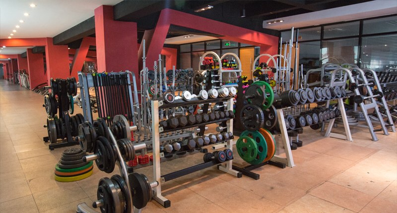 About UnivFitness UnivFitness product showroom with dumbbells weight plates and fitness equipment display
